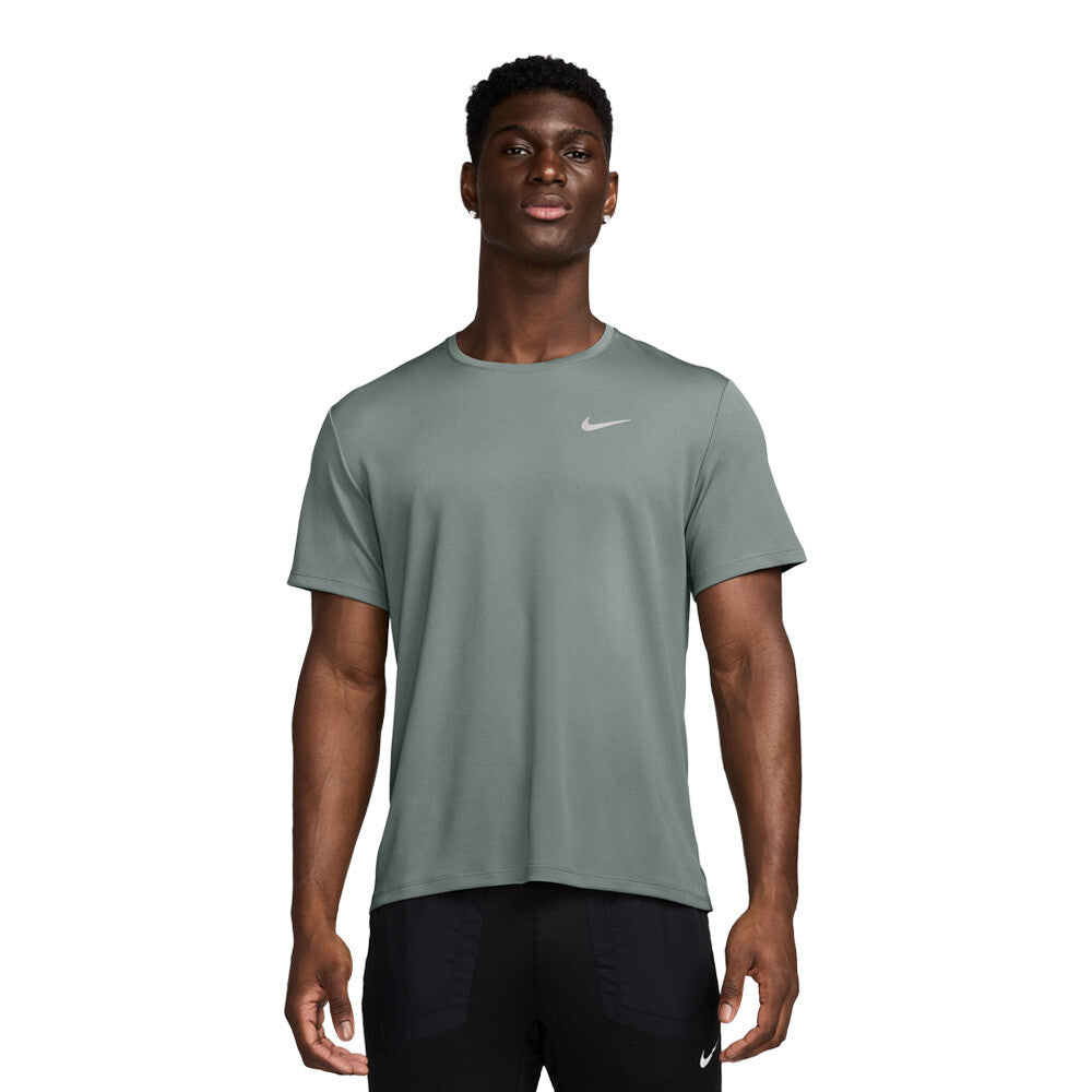 Man wearing a green Nike t-shirt on a white background