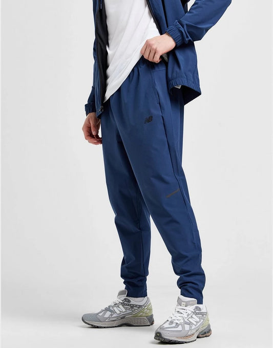 NEW BALANCE ESSENTIAL WOVEN TRACK PANT - BLUE